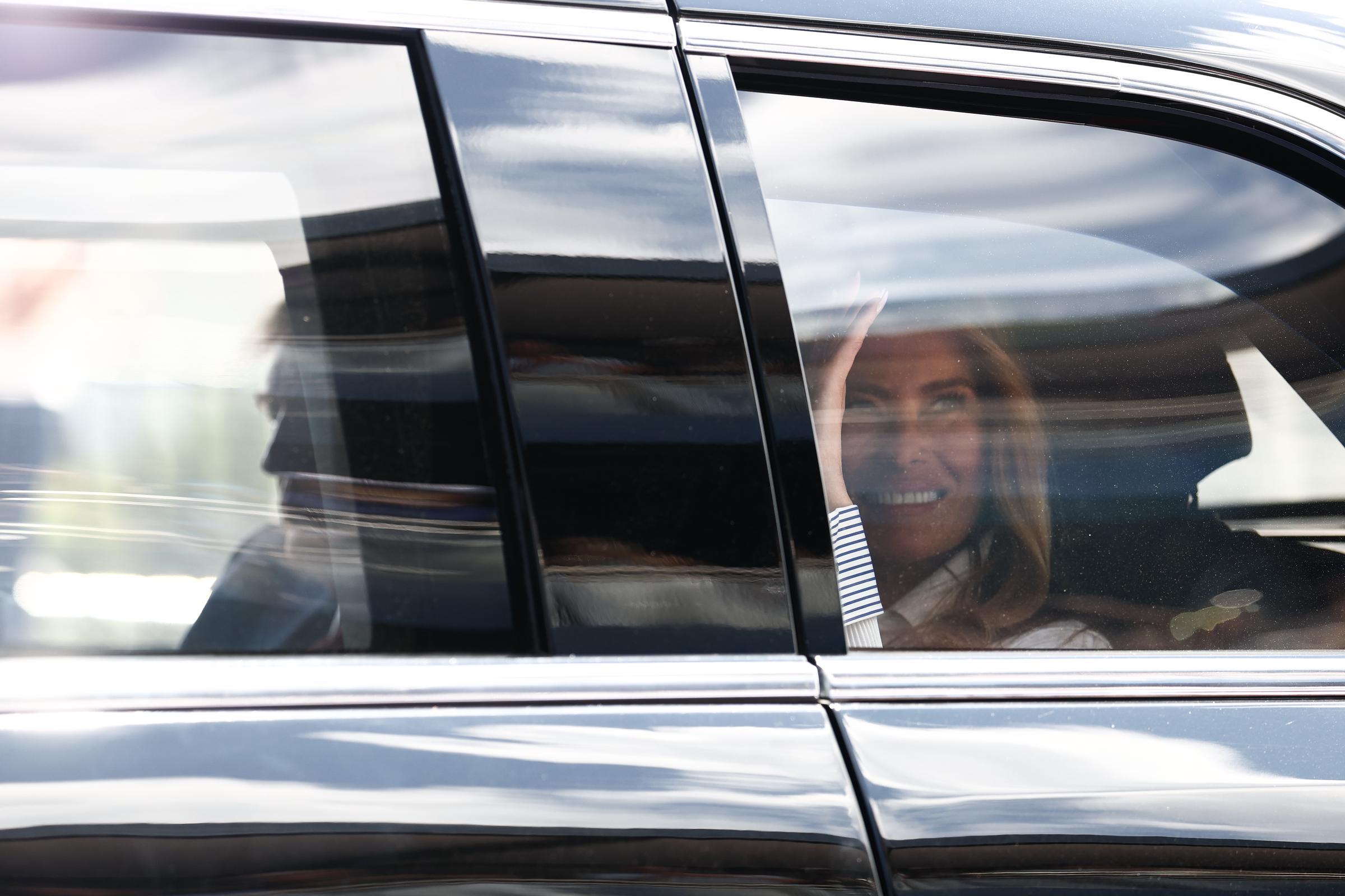 Donald Trump and Melania Trump arrived to greet spectators along the track. In this photo, they waved to fans during the