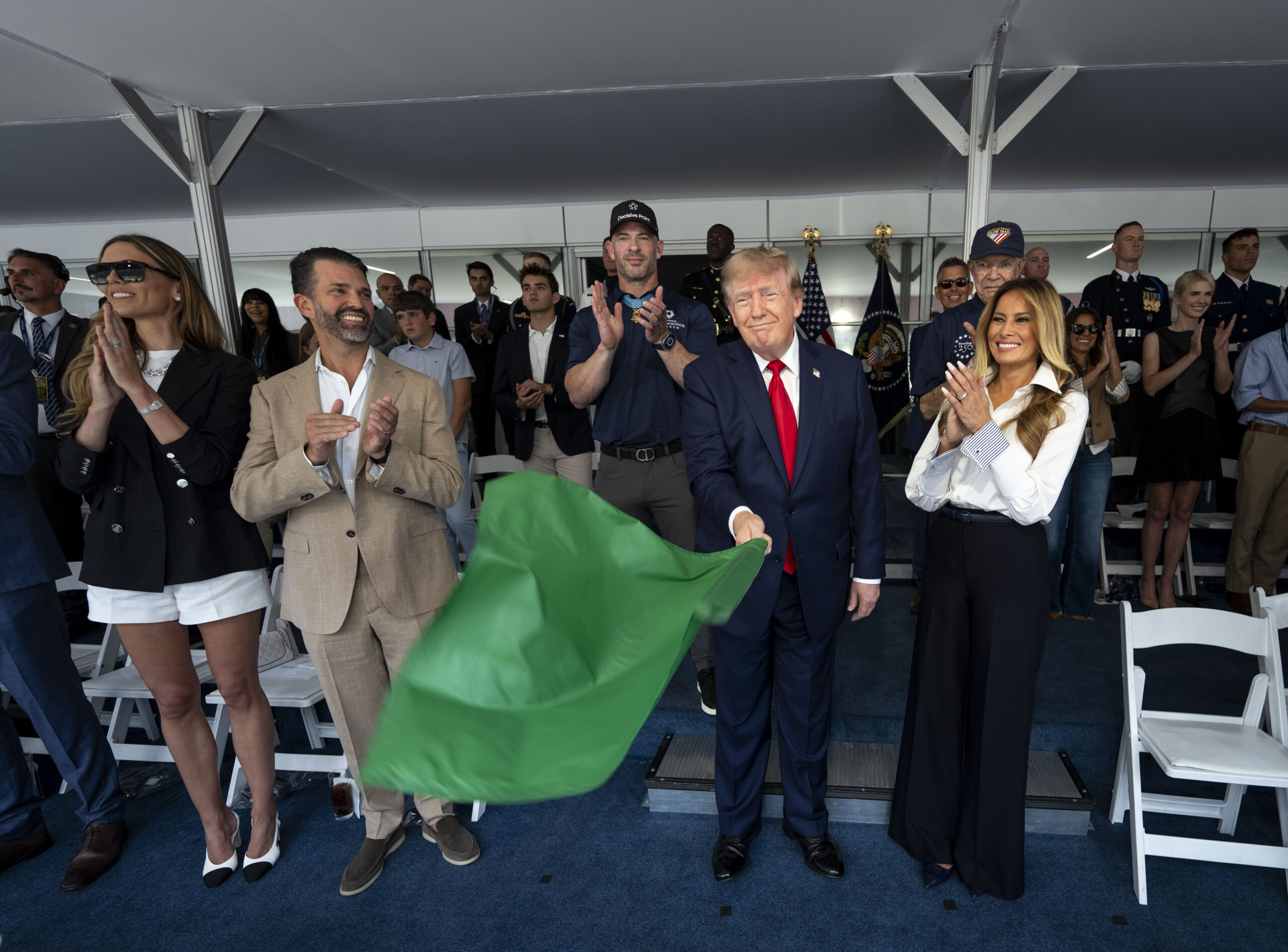 Donald Trump waved the green flag alongside Melania Trump and Donald Trump Jr. during the NTT INDYCAR Series Freedom 250
