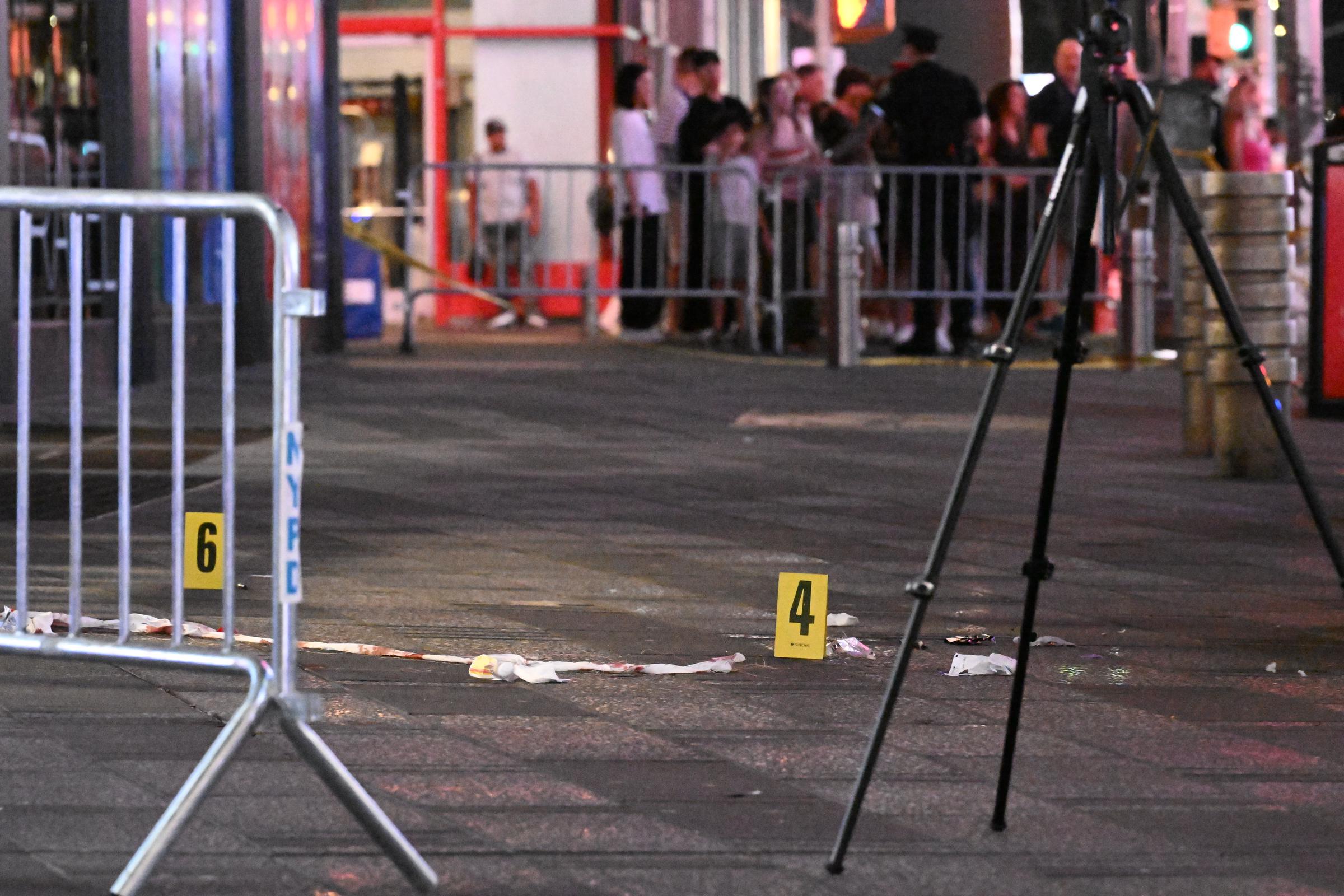 Investigators examined the Times Square scene after the stabbings and subsequent police shooting on August 31. The 68-ye