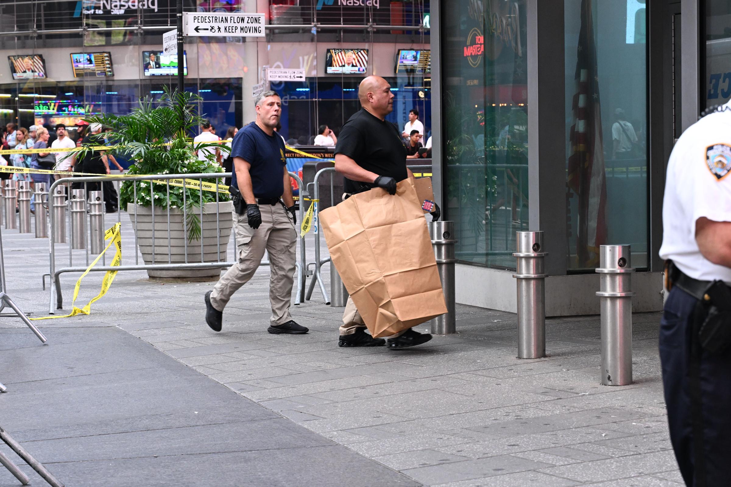 Investigators worked inside the cordoned-off Times Square scene after officers confronted Pamela Cisneros. Police said s