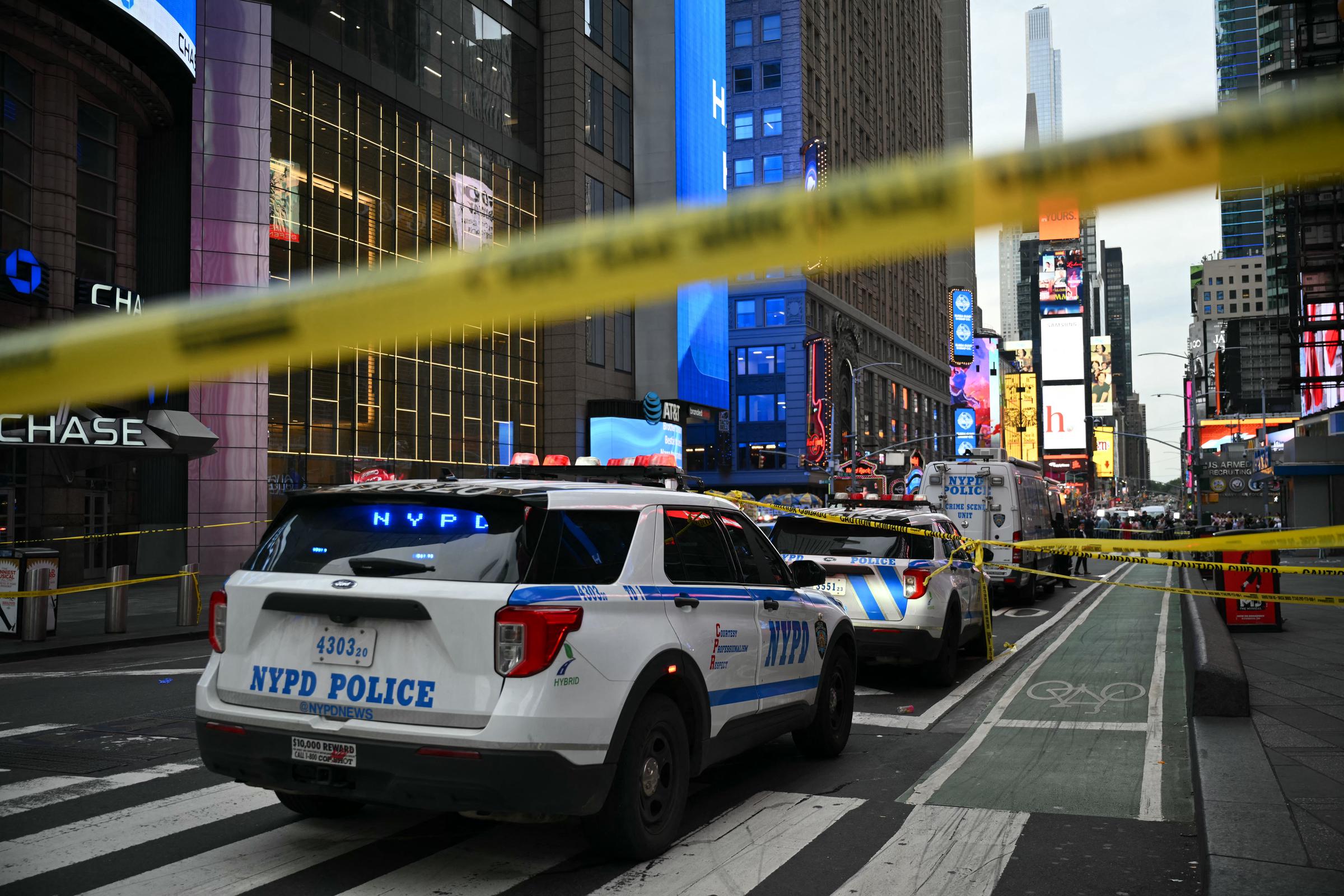 Police vehicles and yellow tape marked off the Times Square area after the August 31 stabbings and police shooting. The