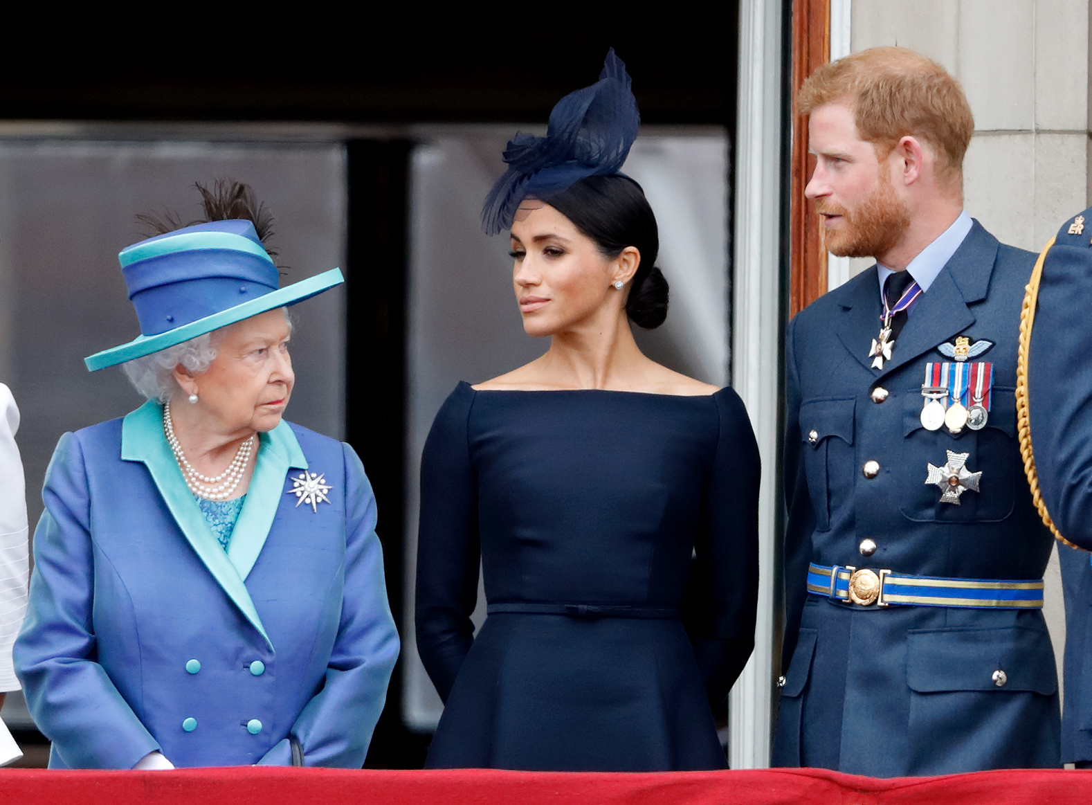Queen Elizabeth II watches Meghan and Prince Harry during the RAF centenary flypast at Buckingham Palace in July 2018. |